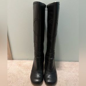Women’s black wedge high boots.